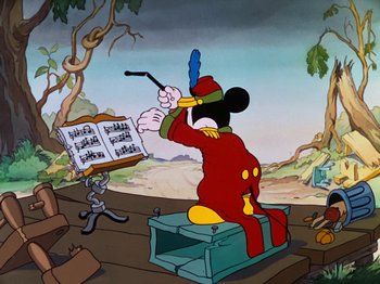 Movie still from “The Band Concert” (1935), directed by Wilfred Jackson – A goofy mouse is playing a musical instrument in front of other cartoon characters; Wide shot, Low angle