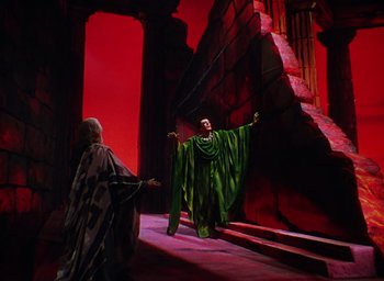 Movie still from “The Band Wagon” (1953), directed by Vincente Minnelli – A man dressed as a wizard is standing in front of another man; Wide shot, Low angle
