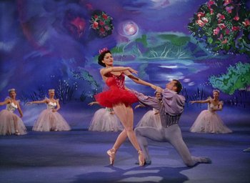 Movie still from “The Band Wagon” (1953), directed by Vincente Minnelli – A couple of people that are dancing in a room; Wide shot, Low angle