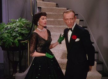 Movie still from “The Band Wagon” (1953), directed by Vincente Minnelli – A man and a woman dressed up in formal wear; Medium shot, High angle