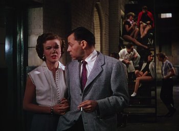 Movie still from “The Band Wagon” (1953), directed by Vincente Minnelli – A man and a woman standing next to each other; Medium shot, Low angle