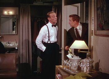 Movie still from “The Band Wagon” (1953), directed by Vincente Minnelli – A man in a white shirt and a man in a black tie; Medium shot, Over the shoulder angle