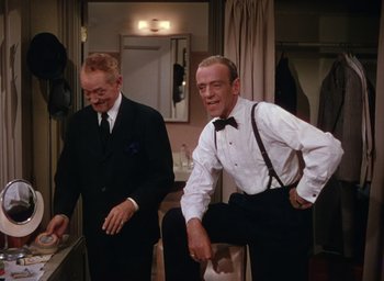Movie still from “The Band Wagon” (1953), directed by Vincente Minnelli – A man in a suit and a man in a bow tie; Medium shot, Low angle
