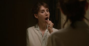 Movie still from “Horse Girl” (2020), directed by Jeff Baena – A woman is brushing her teeth in the mirror; Close Up shot, Over the shoulder angle