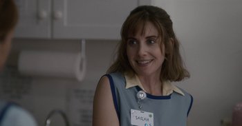 Movie still from “Horse Girl” (2020), directed by Jeff Baena – A woman in a blue shirt is smiling for the camera; Close Up shot, Over the shoulder angle