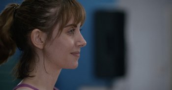 Movie still from “Horse Girl” (2020), directed by Jeff Baena – A woman's face with a blue background; Close Up shot, Over the shoulder angle