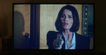 Movie still from “Horse Girl” (2020), directed by Jeff Baena – A woman is holding a gun in front of her face; Close Up shot, Over the shoulder angle