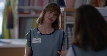 Movie still from “Horse Girl” (2020), directed by Jeff Baena – A woman wearing a name tag talking to a person; Close Up shot, Over the shoulder angle