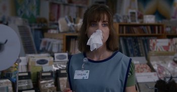 Movie still from “Horse Girl” (2020), directed by Jeff Baena – A woman with a tissue in her mouth; Close Up shot, Over the shoulder angle