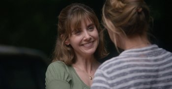 Movie still from “Horse Girl” (2020), directed by Jeff Baena – A woman smiling at another woman in a green shirt; Close Up shot, Over the shoulder angle