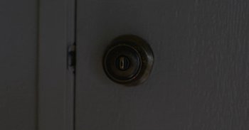Movie still from “Horse Girl” (2020), directed by Jeff Baena – A door knob on a white door; Extreme Close Up shot, High angle