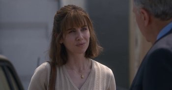 Movie still from “Horse Girl” (2020), directed by Jeff Baena – A young woman with brown hair wearing a beige sweater; Close Up shot, Over the shoulder angle