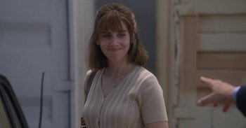 Movie still from “Horse Girl” (2020), directed by Jeff Baena – A woman in a beige sweater smiling for the camera; Close Up shot, Over the shoulder angle