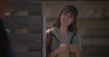 Movie still from “Horse Girl” (2020), directed by Jeff Baena – A woman standing in front of a wooden wall; Close Up shot, Over the shoulder angle