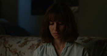 Movie still from “Horse Girl” (2020), directed by Jeff Baena – A woman sitting on a couch with her eyes closed; Close Up shot, Low angle