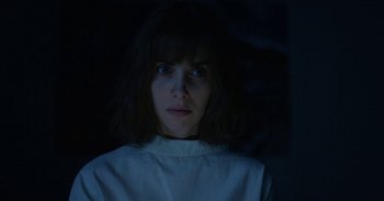 Movie still from “Horse Girl” (2020), directed by Jeff Baena – A woman in a white shirt is looking at the camera; Close Up shot, Low angle