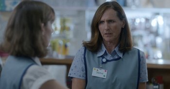 Movie still from “Horse Girl” (2020), directed by Jeff Baena – A woman wearing a name tag talking to another woman; Close Up shot, Over the shoulder angle