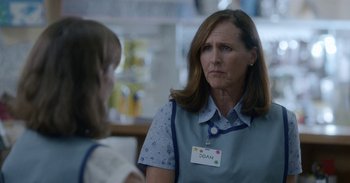 Movie still from “Horse Girl” (2020), directed by Jeff Baena – A woman wearing a name tag talking to another woman; Close Up shot, Over the shoulder angle