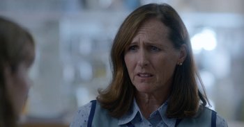 Movie still from “Horse Girl” (2020), directed by Jeff Baena – An older woman is looking at the camera; Close Up shot, Over the shoulder angle