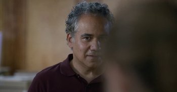 Movie still from “Horse Girl” (2020), directed by Jeff Baena – A person wearing a maroon shirt; Close Up shot, Over the shoulder angle