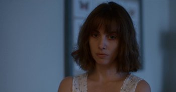 Movie still from “Horse Girl” (2020), directed by Jeff Baena – A person with short brown hair; Close Up shot, Over the shoulder angle