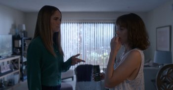 Movie still from “Horse Girl” (2020), directed by Jeff Baena – Two women in a living room , one of whom is holding a can of beer; Medium shot, Over the shoulder angle