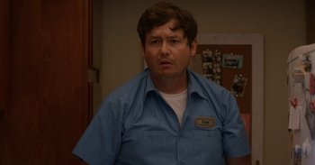 Movie still from “Horse Girl” (2020), directed by Jeff Baena – A man in a blue shirt is looking at the camera; Close Up shot, Low angle