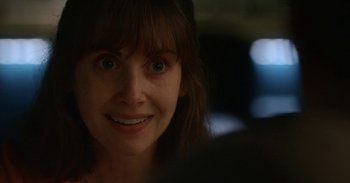 Movie still from “Horse Girl” (2020), directed by Jeff Baena – A woman's face in a dark room; Close Up shot, Over the shoulder angle