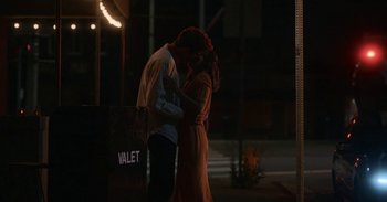 Movie still from “Horse Girl” (2020), directed by Jeff Baena – A man and a woman kissing on the sidewalk; Wide shot, Low angle