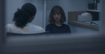 Movie still from “Horse Girl” (2020), directed by Jeff Baena – A woman sitting in front of another woman in front of a mirror; Medium shot, Over the shoulder angle