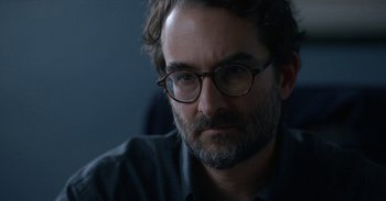 Movie still from “Horse Girl” (2020), directed by Jeff Baena – A person wearing glasses; Close Up shot, Over the shoulder angle