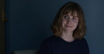 Movie still from “Horse Girl” (2020), directed by Jeff Baena – A person smiling; Close Up shot, Over the shoulder angle