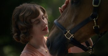 Movie still from “Horse Girl” (2020), directed by Jeff Baena – A woman is petting the face of a brown horse; Close Up shot, Over the shoulder angle