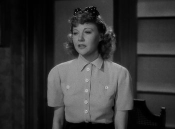 Movie still from “The Bank Dick” (1940), directed by Edward F. Cline – A black and white photo of a woman wearing a hat; Close Up shot, Low angle