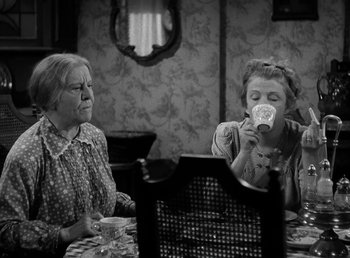 Movie still from “The Bank Dick” (1940), directed by Edward F. Cline – Two women are sitting at a table drinking tea; Medium shot, High angle