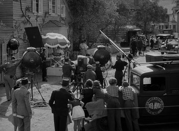 Movie still from “The Bank Dick” (1940), directed by Edward F. Cline – A black and white photo of a group of people on a street; Extreme Wide shot, High angle