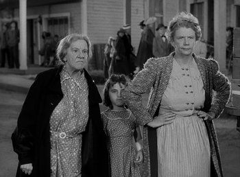 Movie still from “The Bank Dick” (1940), directed by Edward F. Cline – An old photo of two women and a little girl; Medium shot, Low angle