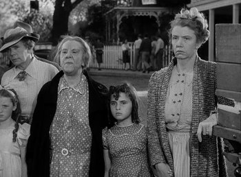 Movie still from “The Bank Dick” (1940), directed by Edward F. Cline – An old black and white photo of a group of people; Medium shot, Low angle