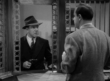 Movie still from “The Bank Dick” (1940), directed by Edward F. Cline – An old photo of a man looking at himself in the mirror; Medium shot, Over the shoulder angle