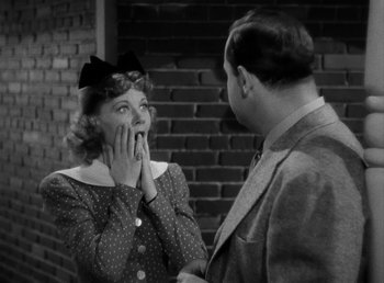 Movie still from “The Bank Dick” (1940), directed by Edward F. Cline – An old photo of a man and a woman; Close Up shot, Over the shoulder angle