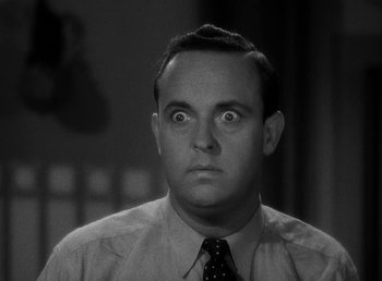 Movie still from “The Bank Dick” (1940), directed by Edward F. Cline – A man in a dress shirt and a tie looking surprised; Close Up shot, Low angle