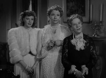 Movie still from “The Bank Dick” (1940), directed by Edward F. Cline – A group of women standing next to each other in a room; Medium shot, Low angle