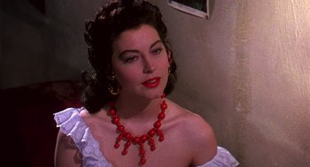 Movie still from “The Barefoot Contessa” (1954), directed by Joseph L. Mankiewicz – A woman with red lipstick and a red necklace; Close Up shot, Over the shoulder angle