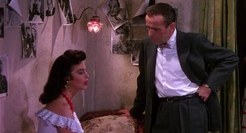 Movie still from “The Barefoot Contessa” (1954), directed by Joseph L. Mankiewicz – A man and a woman standing next to each other in a room; Medium shot, Over the shoulder angle