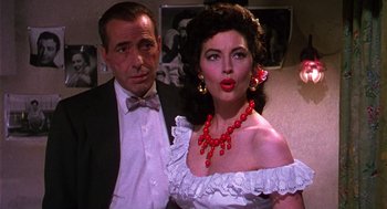 Movie still from “The Barefoot Contessa” (1954), directed by Joseph L. Mankiewicz – A man standing next to a woman in a white dress; Close Up shot, Over the shoulder angle