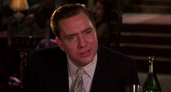 Movie still from “The Barefoot Contessa” (1954), directed by Joseph L. Mankiewicz – A man in a suit and a tie; Close Up shot, Over the shoulder angle