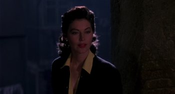 Movie still from “The Barefoot Contessa” (1954), directed by Joseph L. Mankiewicz – A woman in a yellow shirt and a black jacket; Close Up shot, Over the shoulder angle