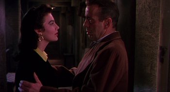 Movie still from “The Barefoot Contessa” (1954), directed by Joseph L. Mankiewicz – A man and a woman standing next to each other; Close Up shot, Over the shoulder angle