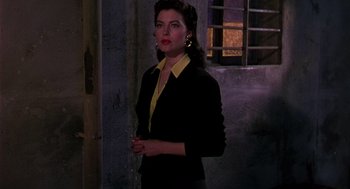 Movie still from “The Barefoot Contessa” (1954), directed by Joseph L. Mankiewicz – A woman in a black jacket and yellow shirt; Medium shot, Low angle