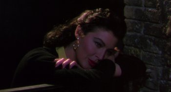 Movie still from “The Barefoot Contessa” (1954), directed by Joseph L. Mankiewicz – A beautiful woman leaning against a brick wall; Close Up shot, High angle